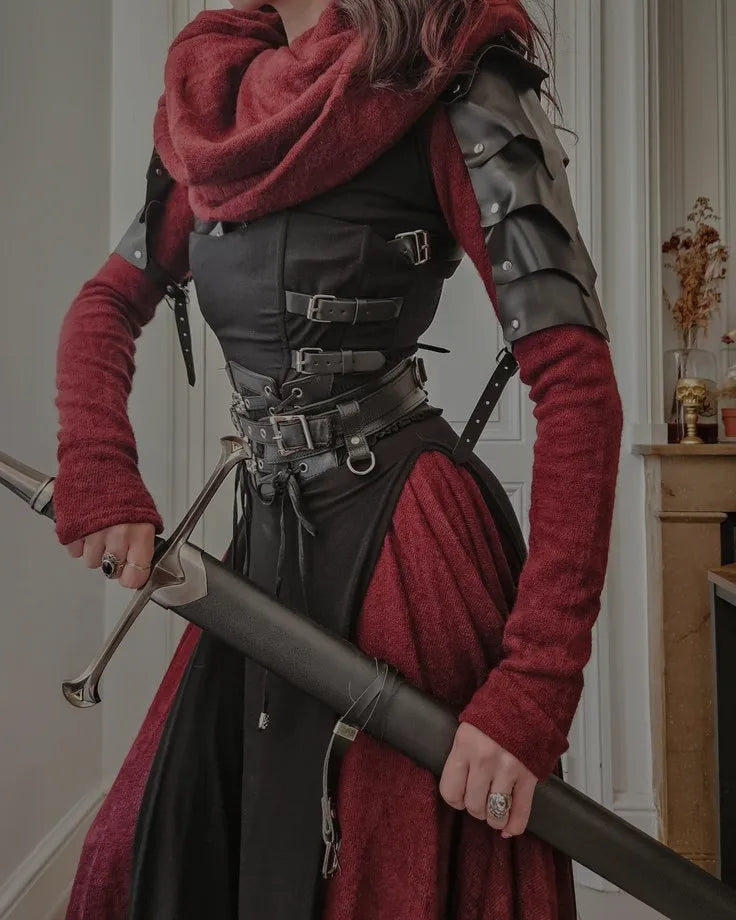 A fantasy-themed medieval rogue costume set featuring a red cloak, leather pauldrons, buckled corset, and a sword with a scabbard.