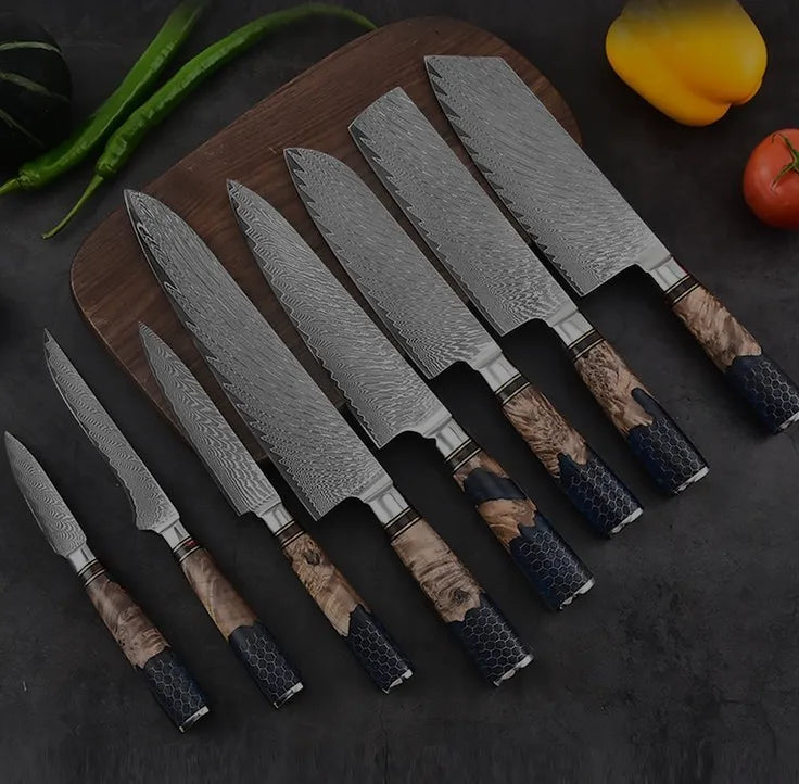 A complete 7-piece set of professional Damascus steel kitchen knives featuring unique wood and blue honeycomb resin handles, displayed on a wooden board.