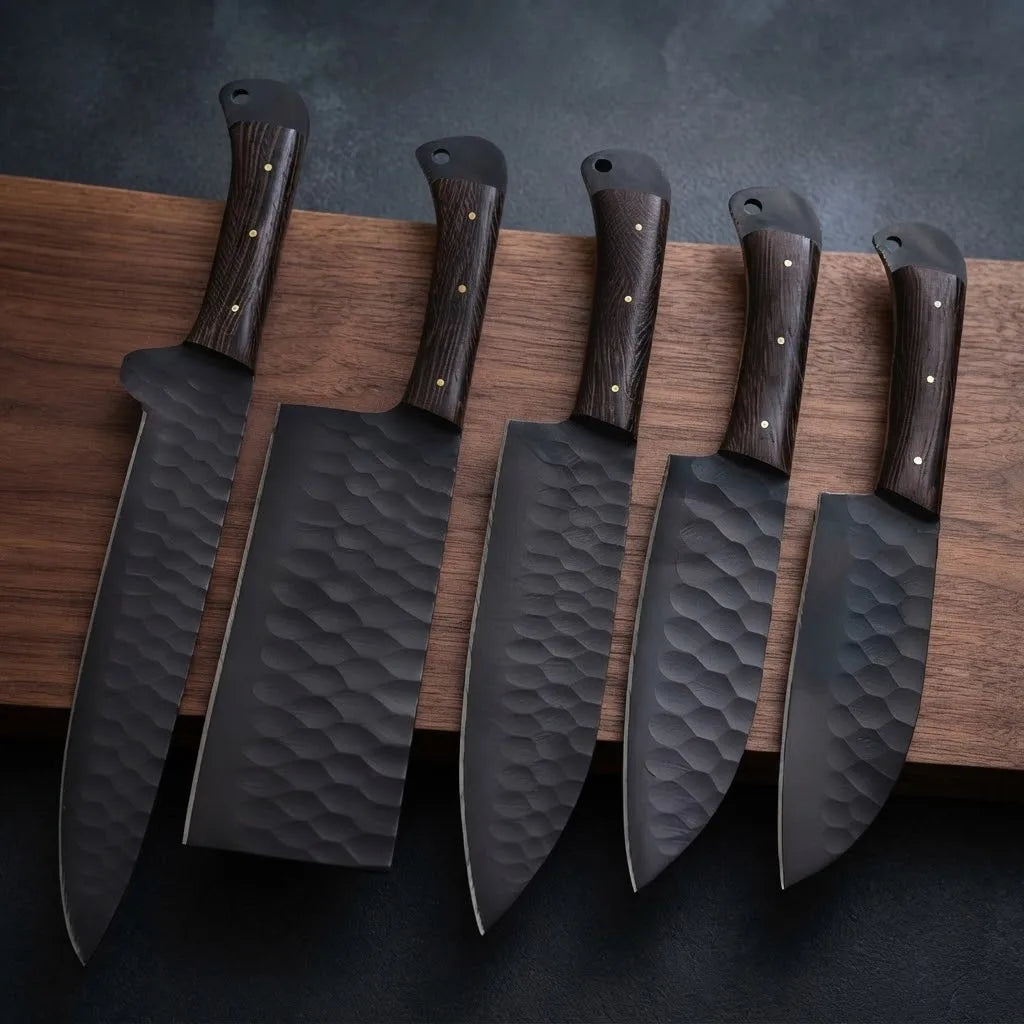 A professional 5-piece culinary knife set featuring dark hammered carbon steel blades and natural hardwood handles, displayed on a wooden cutting board for kitchen display and culinary use.