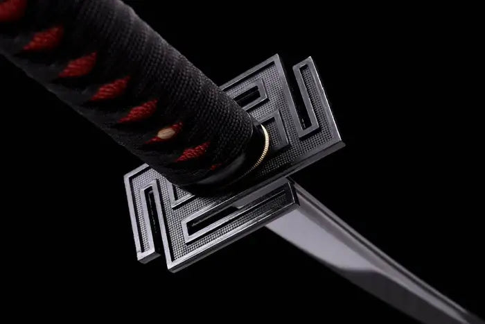 Close-up shot of a black geometric square tsuba handguard on a Japanese samurai katana, showcasing the textured maze pattern, black and red wrapped hilt, and sleek blade edge.