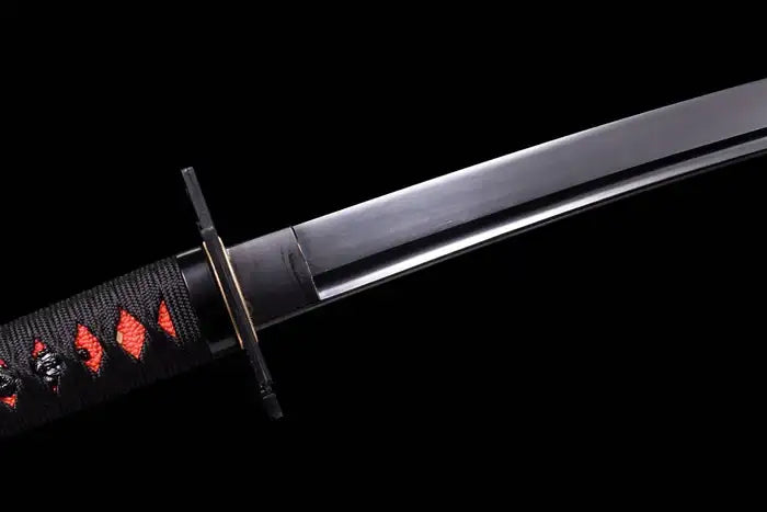 Close-up of a sleek black katana blade and collar habaki, featuring a black wrapped hilt over red ray skin and a minimalist black square tsuba handguard against a dark backdrop.