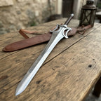 A premium custom fantasy short sword with an intricate metal guard, displayed on a rustic wooden table alongside its leather scabbard and a vintage lantern.