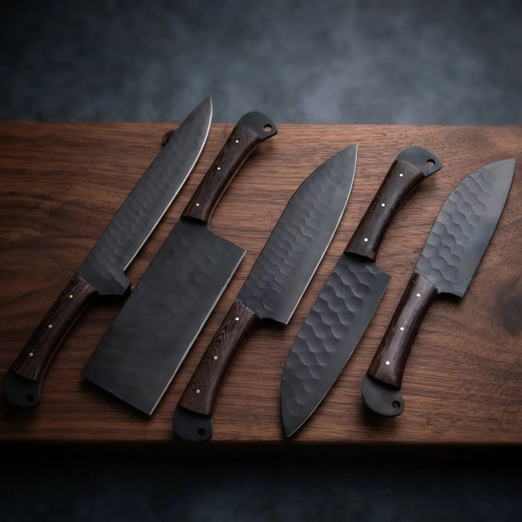 A 5-piece professional culinary knife set showcasing handcrafted hammered dark steel blades and durable wood handles, arranged on a natural walnut cutting board for kitchen display.
