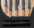 A premium 5-piece culinary knife set with hammered finish blades and blue resin/wood handles, displayed alongside a professional leather roll-up storage case.
