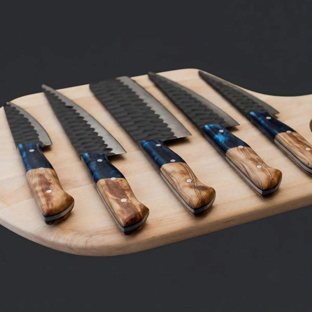 A premium 5-piece kitchen knife set with hammered finish blades and unique blue resin and wood handles, arranged on a wooden board.
