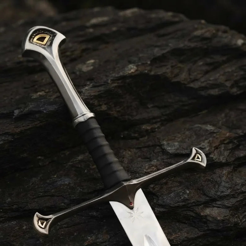 Close-up of a handmade medieval king's sword replica featuring intricate metalwork on the pommel and crossguard, with a leather-wrapped grip