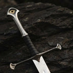 Close-up of a handmade medieval king's sword replica featuring intricate metalwork on the pommel and crossguard, with a leather-wrapped grip