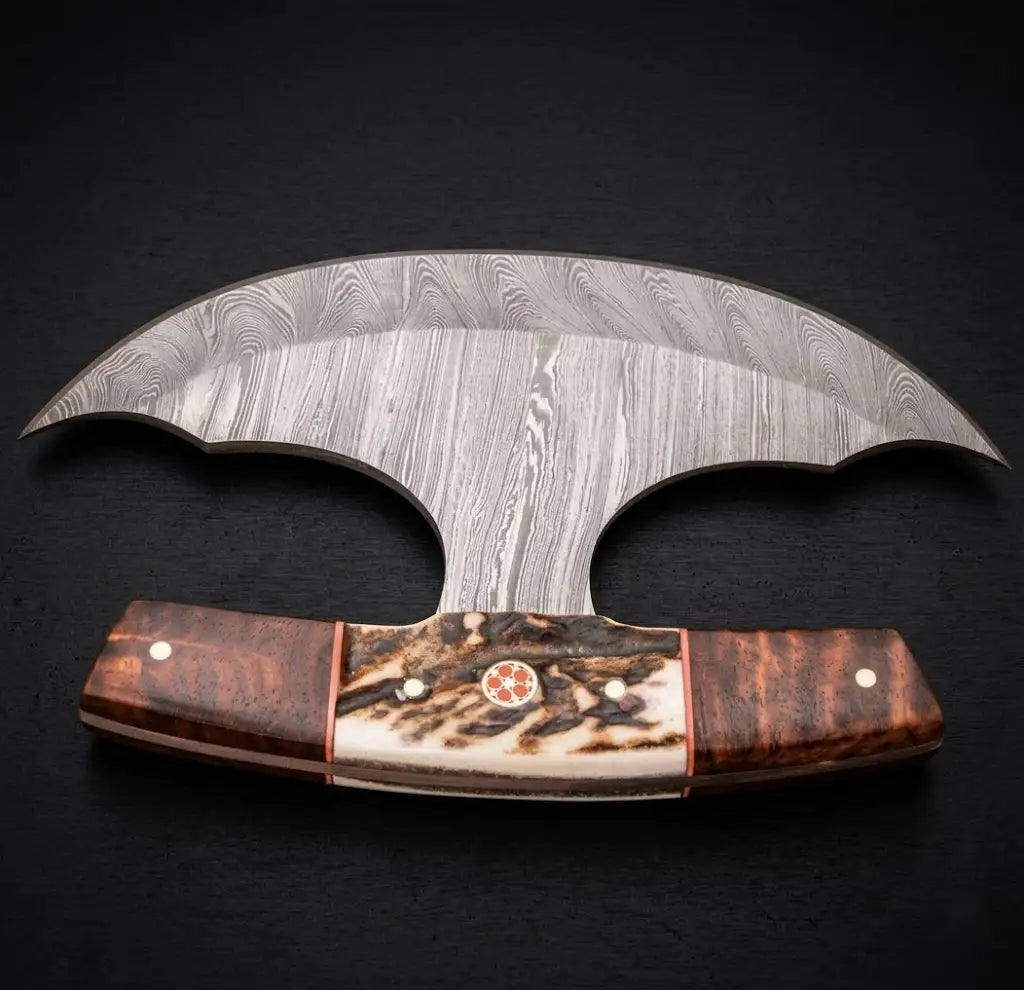 A muscular arm holding a handcrafted replica of Kratos' Leviathan axe raised against a dark grey studio background, showcasing the large steel bearded blade with detailed runic engravings, inlaid blue glowing gems, and an intricately carved wooden handle wrapped in black leather.