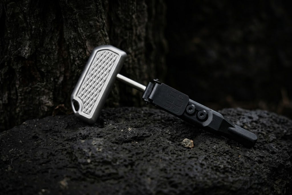 High-quality custom titanium push dagger EDC tool with a durable sheath, captured in a professional product photography style.