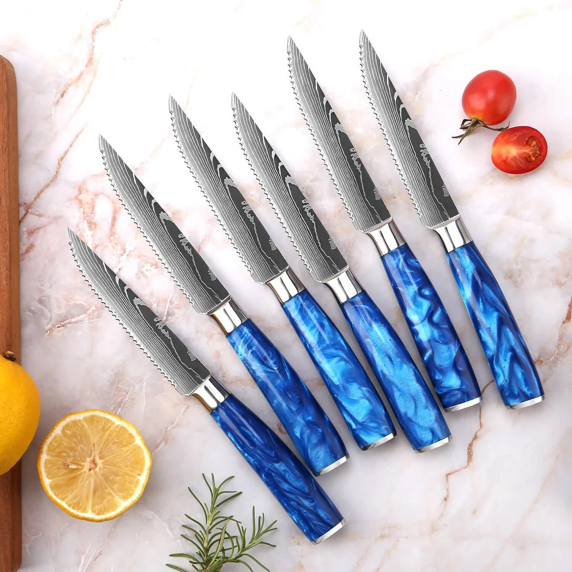 IronClad Customs Cerulean Collection Damascus kitchen knife set, premium chef, cleaver, and santoku blades displayed on a rustic wood board.