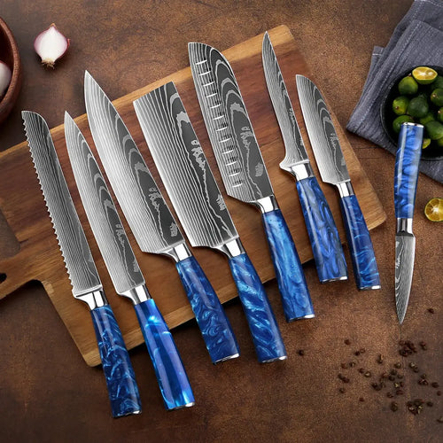 High-contrast Damascus steel kitchen knives with vibrant blue resin handles arranged on a wooden cutting board with fresh limes and onions on a textured rustic background.