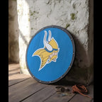 Close-up of the hand-painted Viking shield's weathered finish