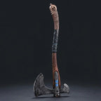 Hand-forged Viking bearded axe featured upside down on a dark background, showing an intricately carved wooden handle with a wolf head pommel, leather wrapping, and engraved runes on the metal blade.