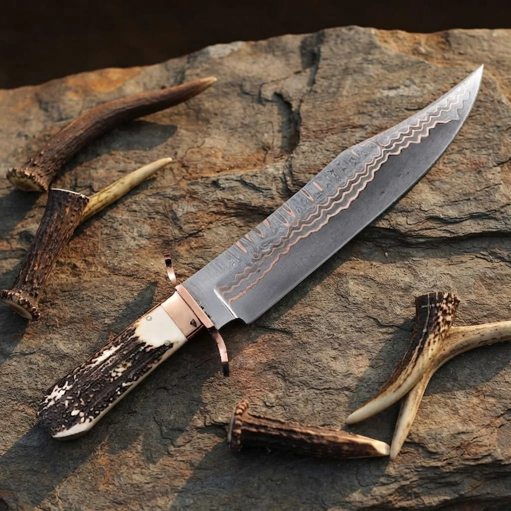 A professional handmade Copper Damascus Bowie knife displayed on a rugged stone surface, showcasing its natural antler handle, copper guard, and intricate blade pattern