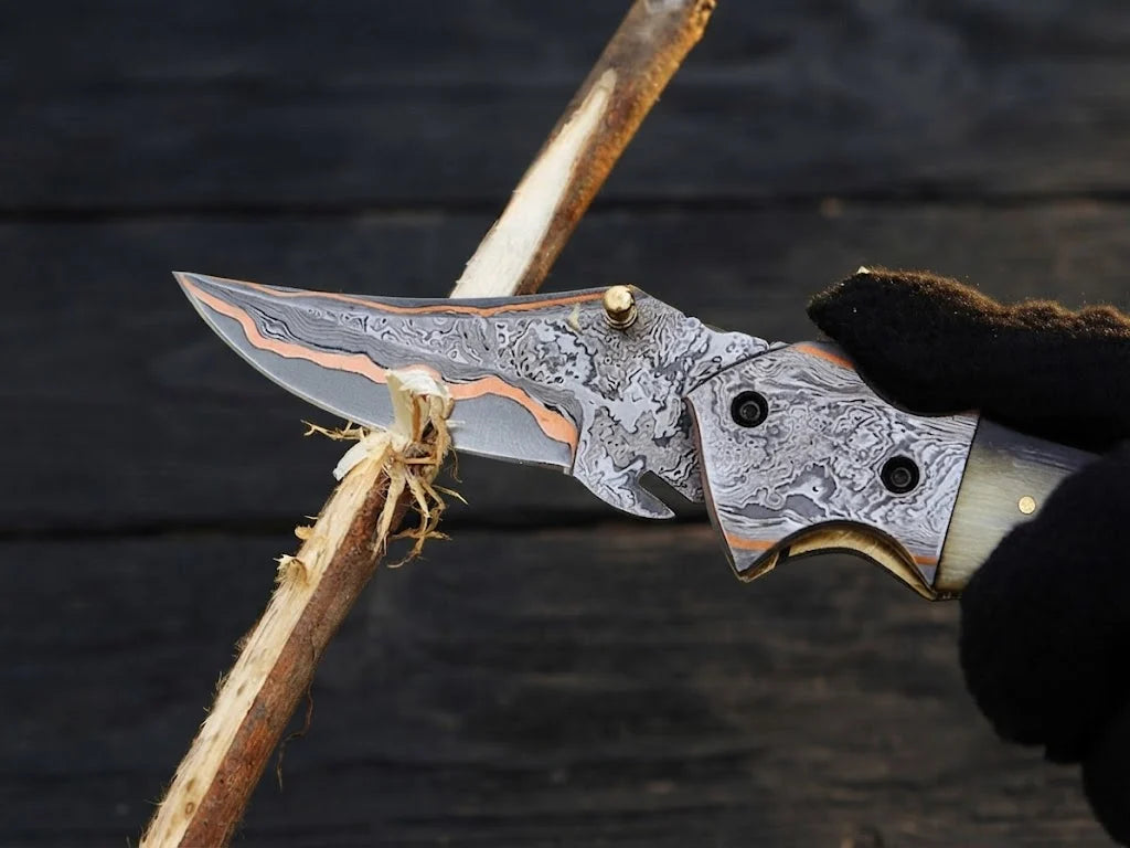 High-quality custom copper Damascus steel pocket knife highlighting functional outdoor wood carving and unique forged ripple patterns for collectors and gift buyers