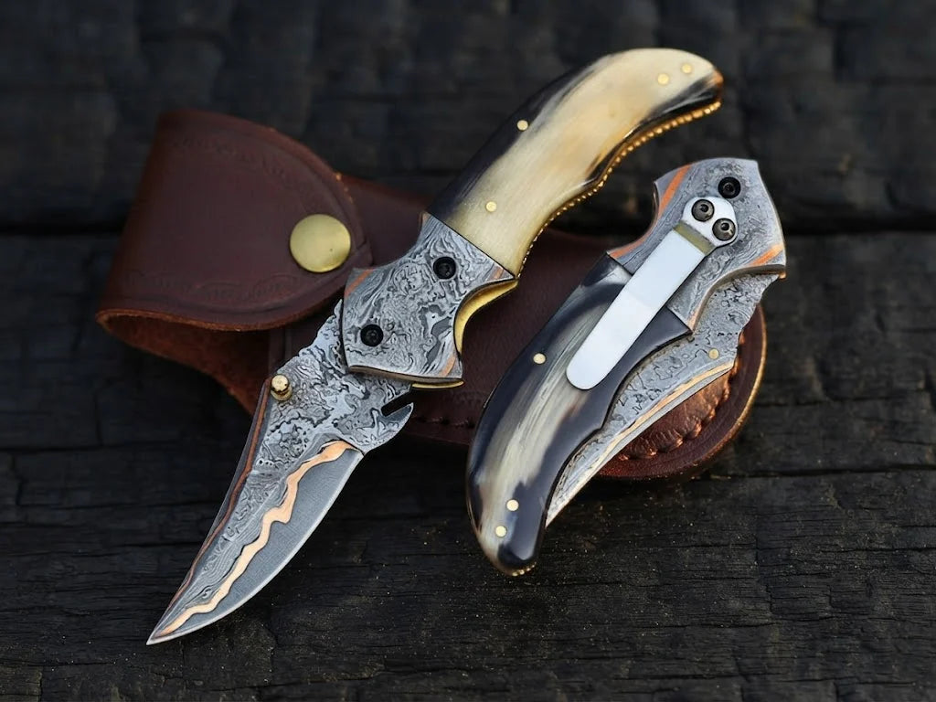 High-quality custom copper Damascus steel pocket knife highlighting the reverse pocket clip, vibrant copper layers, and organic horn handle material for collectors