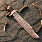 A professional handmade Damascus Bowie knife featuring a 14-inch blade and Wenge wood handle, displayed on a textured stone surface with natural antler accents