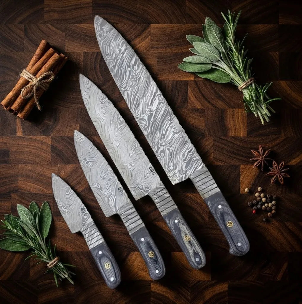 A professional set of hand-forged Damascus steel kitchen knives featuring sleek, dark handles, elegantly arranged with fresh sage, cinnamon sticks, and spices on a dark wooden board.