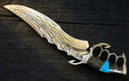 A professional full studio shot of a handmade Damascus steel fantasy medieval dagger featuring a skeleton knuckle-duster handle embedded with a vibrant turquoise stone on a dark wooden surface