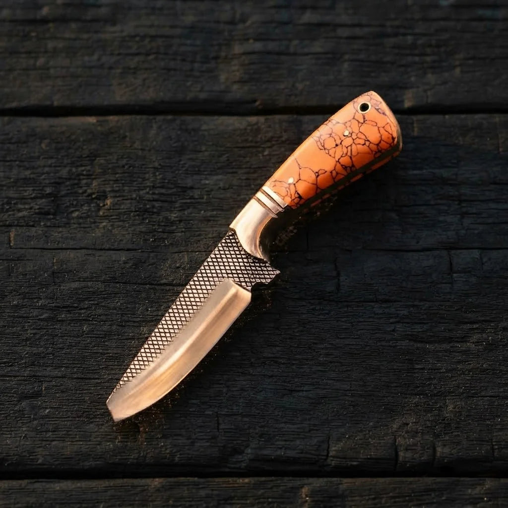 A professional handmade Rasp Forged D2 steel skinning knife featuring a vibrant turquoise marble handle and copper bolster, displayed on a dark rustic wooden background