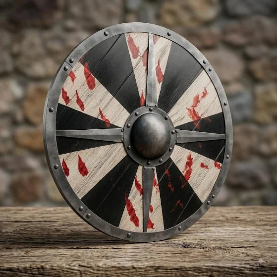 Close-up of the battle-worn Viking shield's steel boss and spearhead inlays