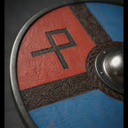 Viking round shield displayed on wall, Nordic rune design