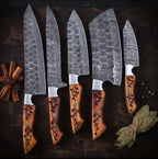 A set of luxury hand-forged Damascus steel kitchen knives featuring unique wavy blade patterns and intricate, hand-carved wooden handles, arranged with cinnamon and bay leaves