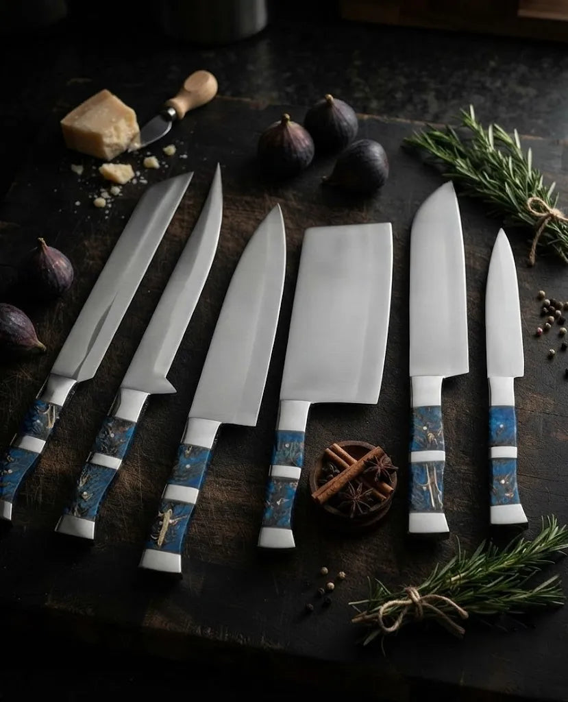 A professional 6-piece kitchen knife set featuring sharp stainless steel blades and unique, artistic blue resin handles on a dark wooden cutting board with culinary ingredients