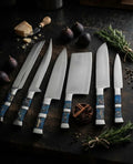 A professional 6-piece kitchen knife set featuring sharp stainless steel blades and unique, artistic blue resin handles on a dark wooden cutting board with culinary ingredients