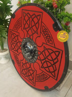 Handcrafted red Viking shield displayed as wall decor
