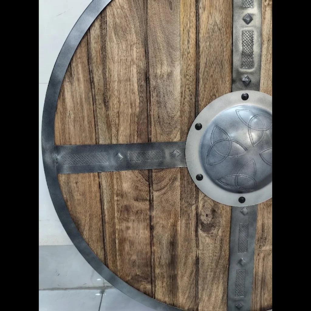 Handcrafted medieval shield displayed as wall decor